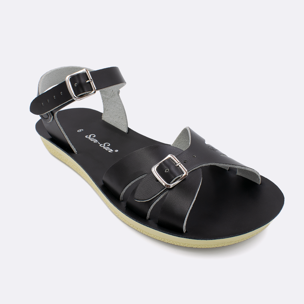 One Women's sized 1900 Boardwalk style sandal with black straps and a black insole. Facing left to right diagonally. 