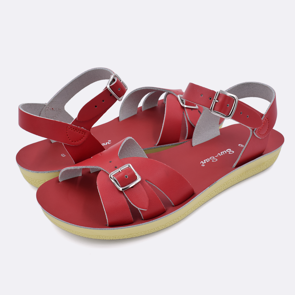 Two Women's sized 1900 Boardwalk style sandals with red straps and red insoles. Both pushed together facing the camera diagonally.