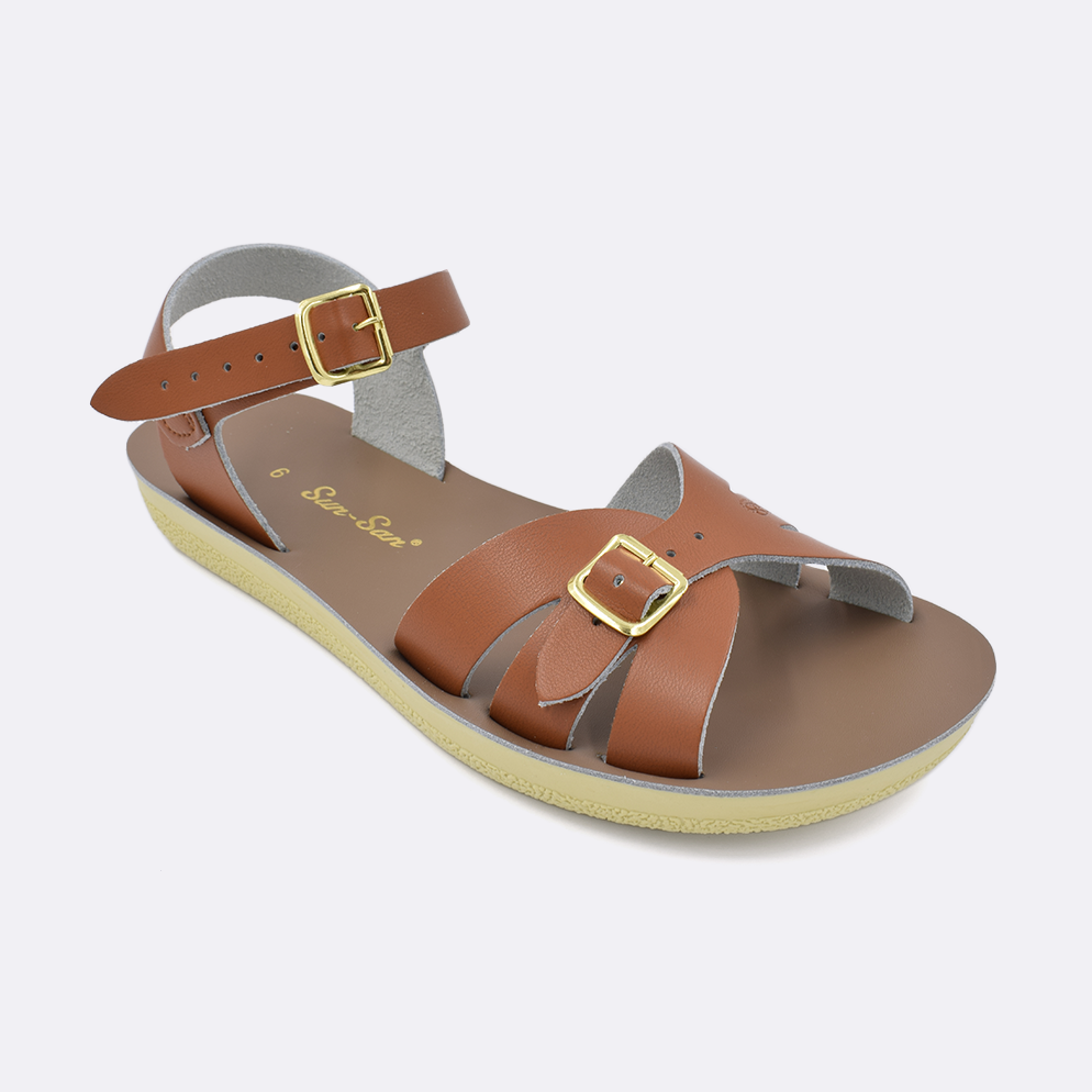 One Women's sized 1900 Boardwalk style sandal with tan straps and a beige insole. Facing left to right diagonally. 