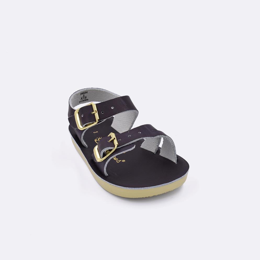 One baby sized 2000 Sea Wee style sandal with brown straps and a brown insole. Facing left to right diagonally. 