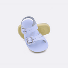 Two baby sized 2000 Sea Wee style sandals with light blue straps and light blue insoles.  One standing with the sole facing the camera. The second is laying diagonally over the top left edge of the sole.