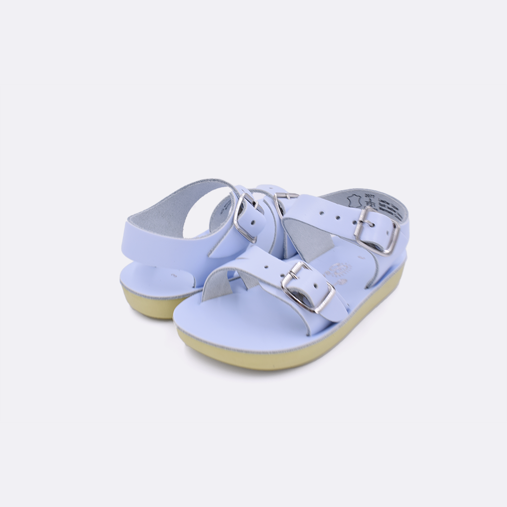Two baby sized 2000 Sea Wee style sandals with light blue straps and light blue insoles. Both pushed together facing the camera diagonally.