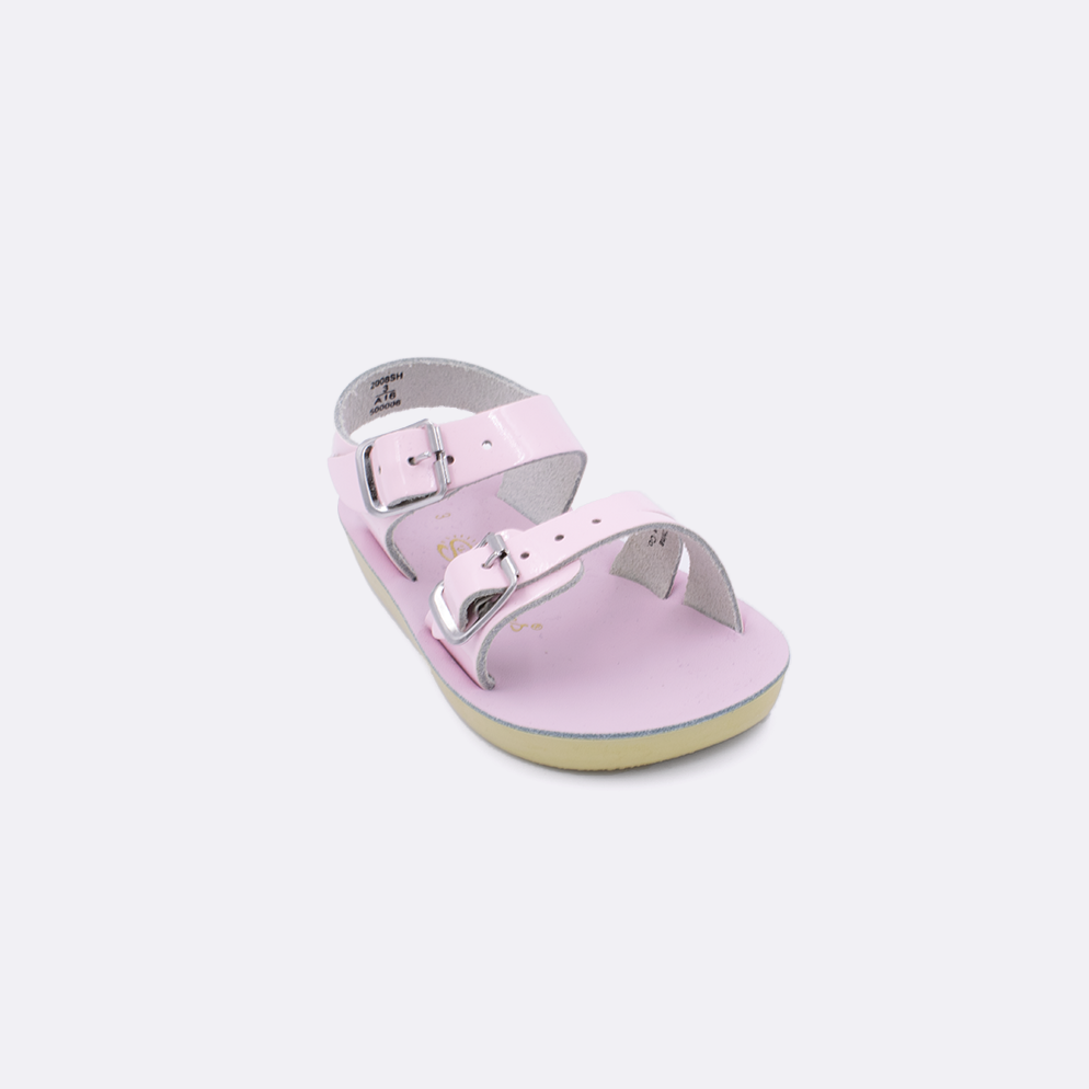 One baby sized 2000 Sea Wee style sandal with shiny pink straps and a shiny pink insole. Facing left to right diagonally. 