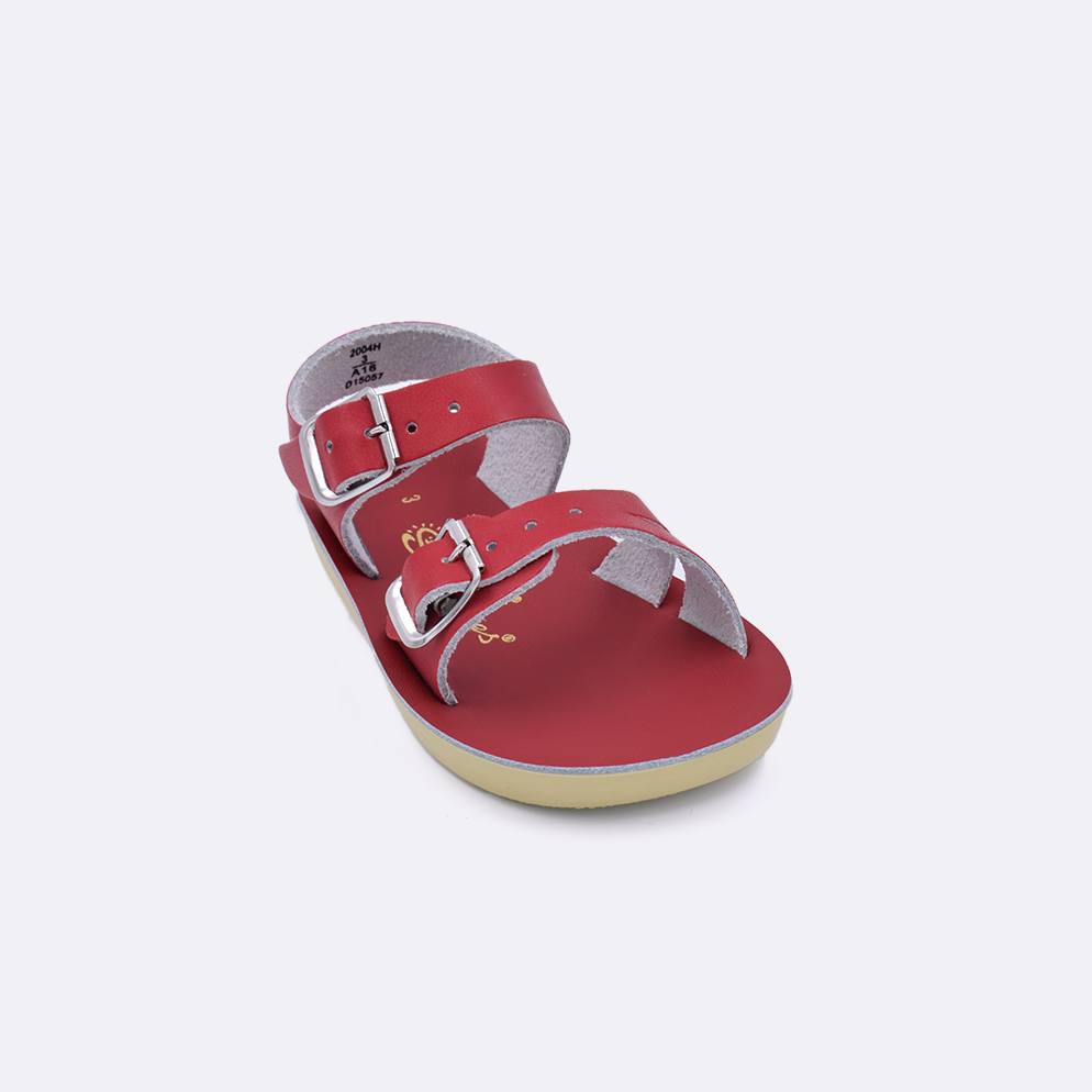 One baby sized 2000 Sea Wee style sandal with red straps and a red insole. Facing left to right diagonally. 