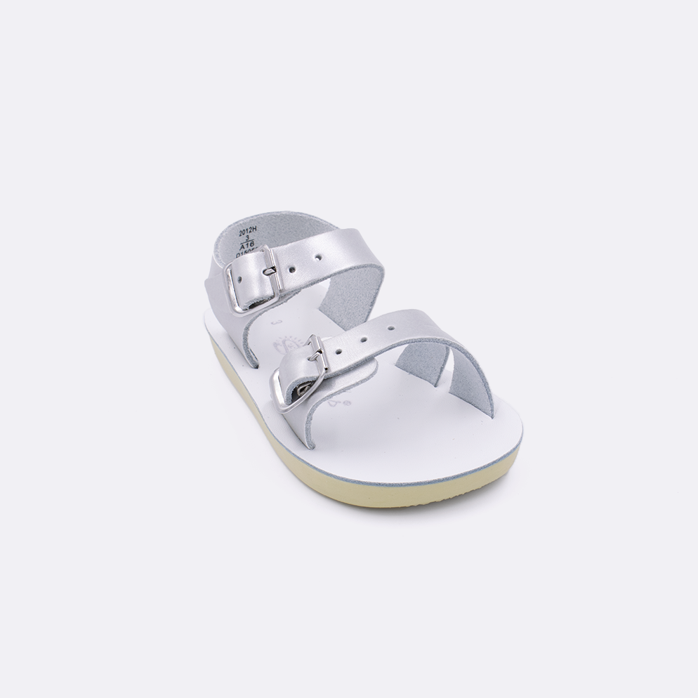 One baby sized 2000 Sea Wee style sandal with silver straps and a white insole. Facing left to right diagonally. 