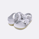Two baby sized 2000 Sea Wee style sandals with silver straps and white insoles. Both pushed together facing the camera diagonally.