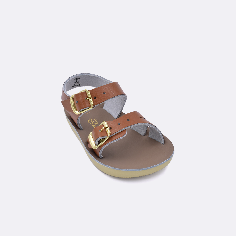 One baby sized 2000 Sea Wee style sandal with tan straps and a beige insole. Facing left to right diagonally. 