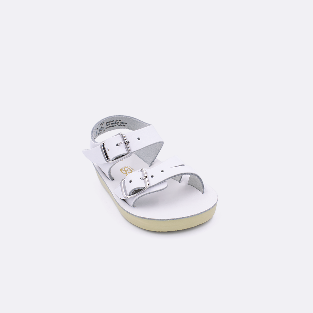 One baby sized 2000 Sea Wee style sandal with white straps and a beige insole. Facing left to right diagonally. 