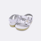 Two baby sized 2000 Sea Wee style sandals with white straps and beige insoles. Both pushed together facing the camera diagonally.