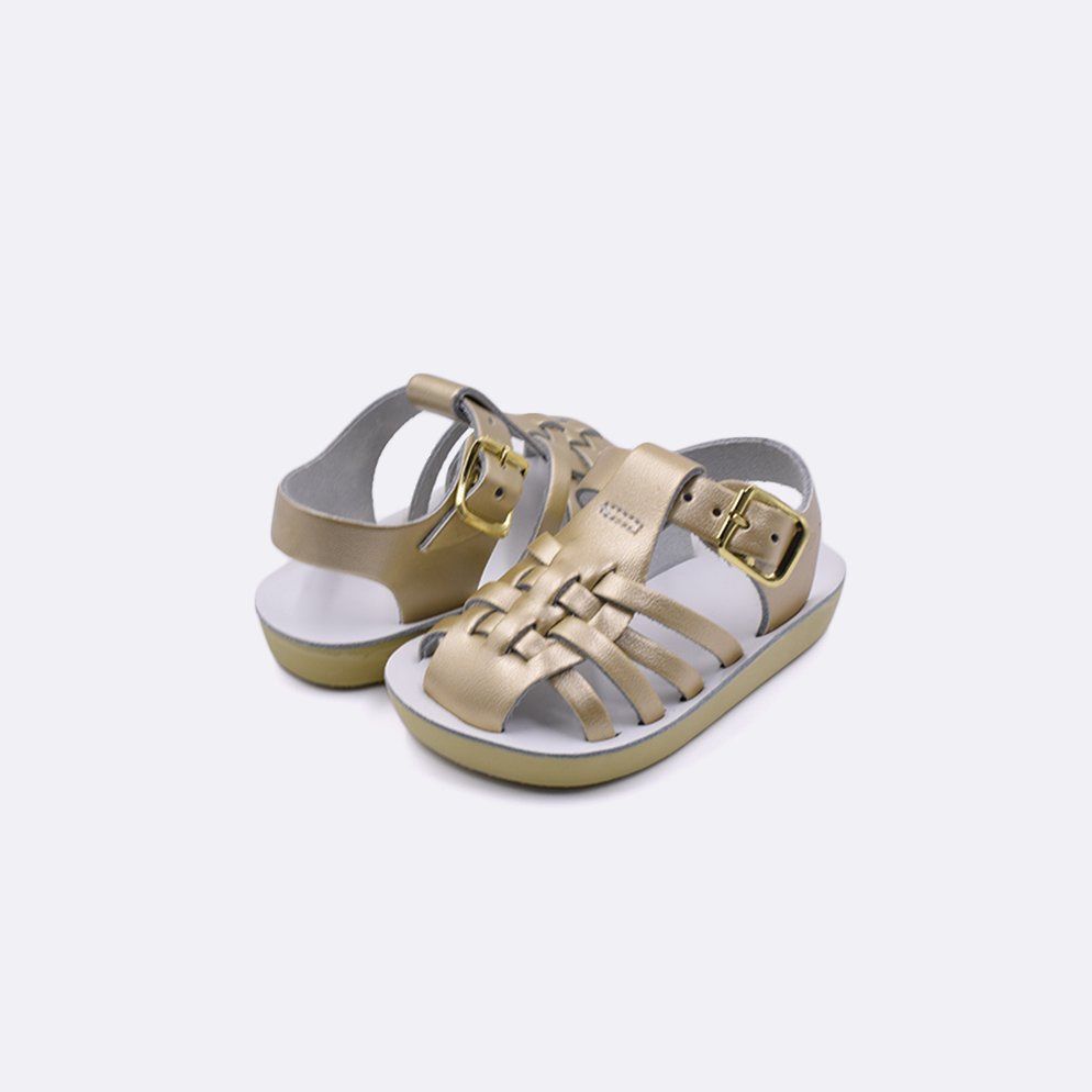 Two baby sized 4200 Sailor style sandals with gold straps and white insoles. Both pushed together facing the camera diagonally.