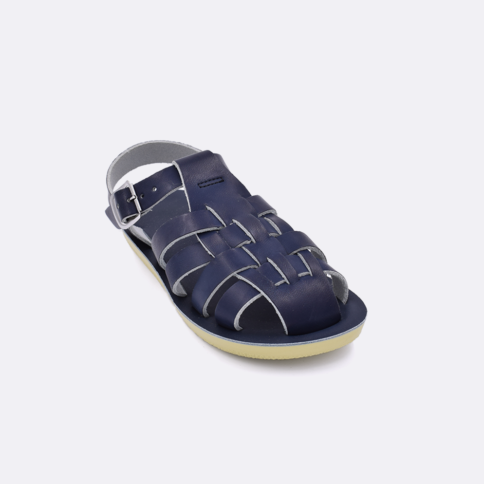 One little kid sized 4200 Sailor style sandal with navy straps and a navy insole. Facing left to right diagonally. 