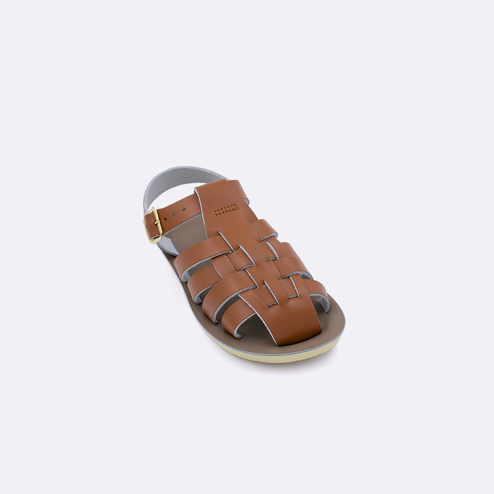 One toddler sized 4200 Sailor style sandal with tan straps and a beige insole. Facing left to right diagonally. 