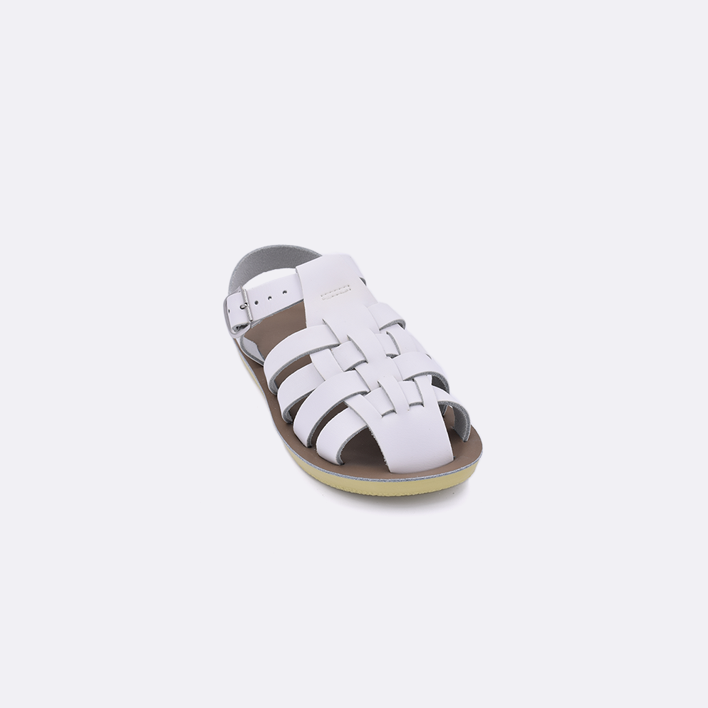 One toddler sized 4200 Sailor style sandal with white straps and a beige insole. Facing left to right diagonally. 