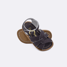 Two 800 Original style sandals color brown.  One standing with the sole facing the camera. The second is laying diagonally over the top left edge of the sole.	Baby size