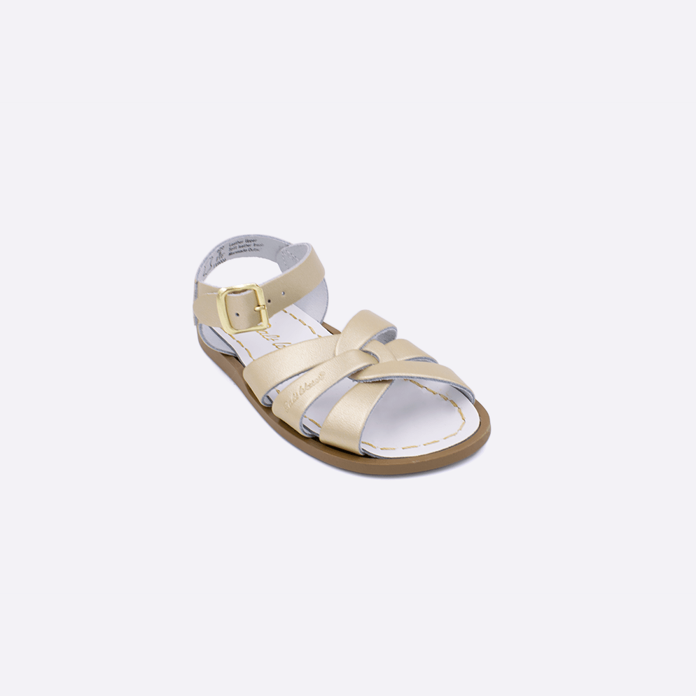 One toddler sized 800 Original style sandal with gold straps and a white insole. Facing left to right diagonally. 