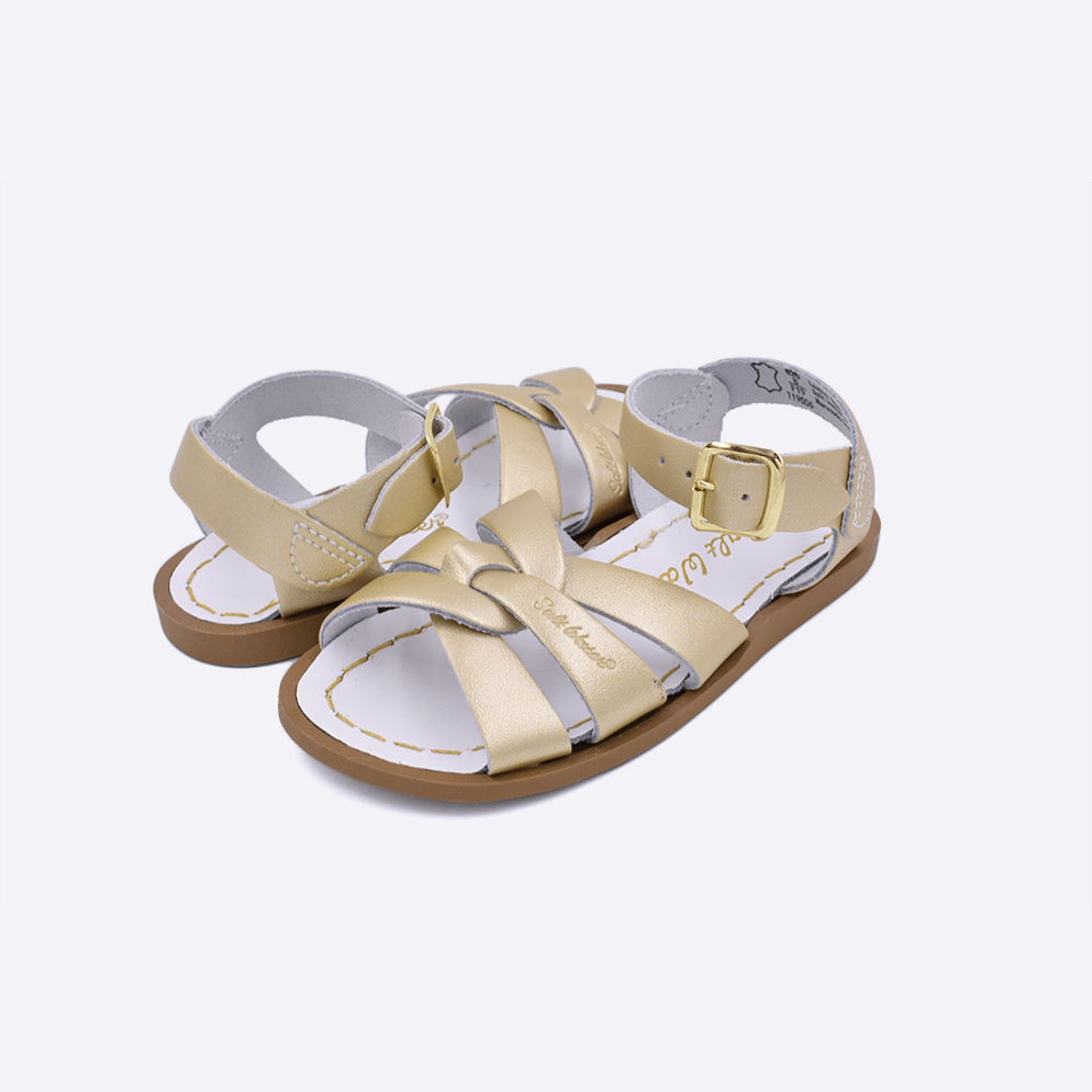 Two toddler sized 800 Original style sandals with gold straps and white insoles. Both pushed together facing the camera diagonally.