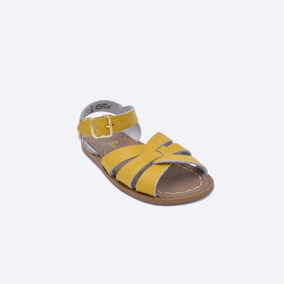 One toddler sized 800 Original style sandal with mustard straps and a beige insole. Facing left to right diagonally. 