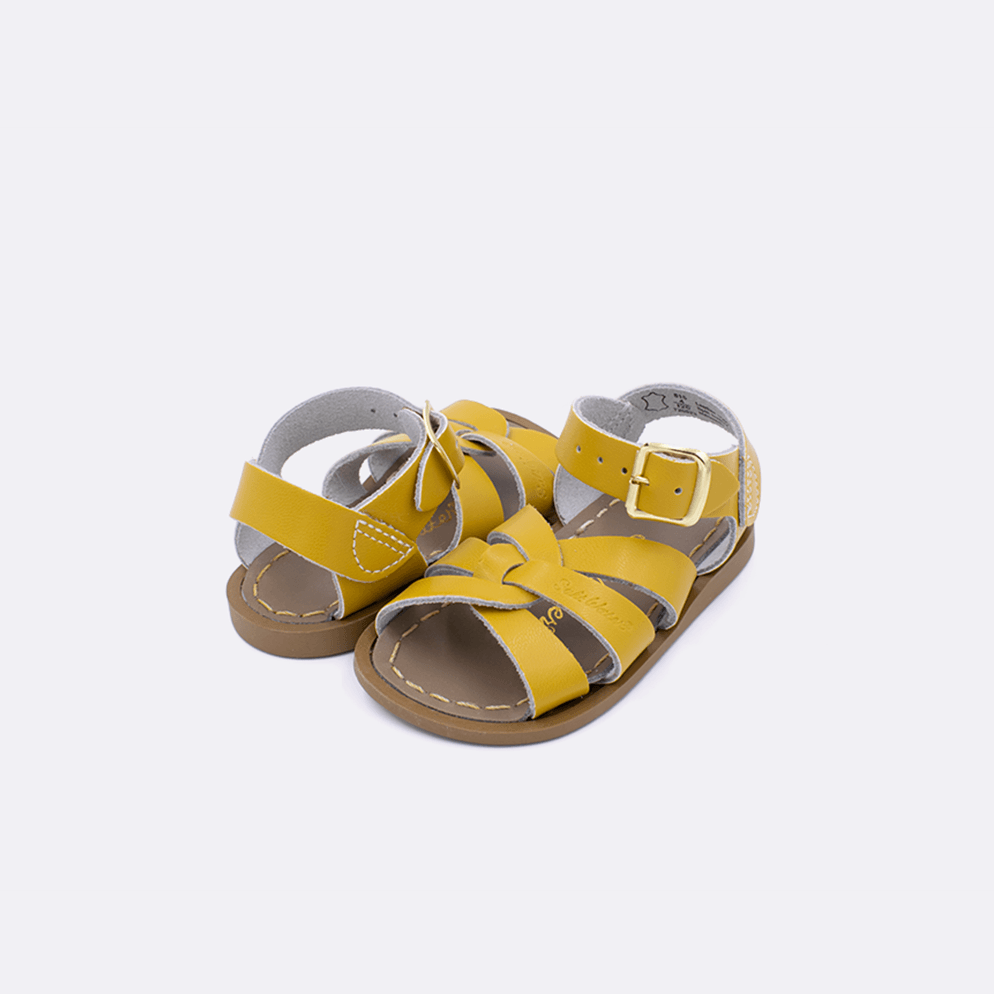 Two baby size 800 Original style sandal color mustard. Both pushed together facing the camera diagonally.	