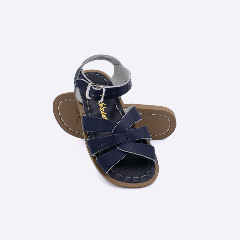 Two toddler sized 800 Original style sandals with navy straps and navy insoles.  One standing with the sole facing the camera. The second is laying diagonally over the top left edge of the sole.