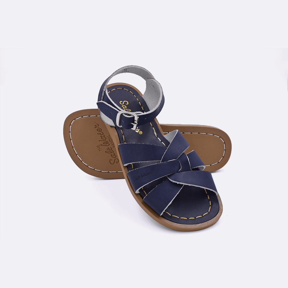 Two navy little kid sized 800 Original style sandals.  One standing with the sole facing the camera. The second is laying diagonally over the top left edge of the sole.