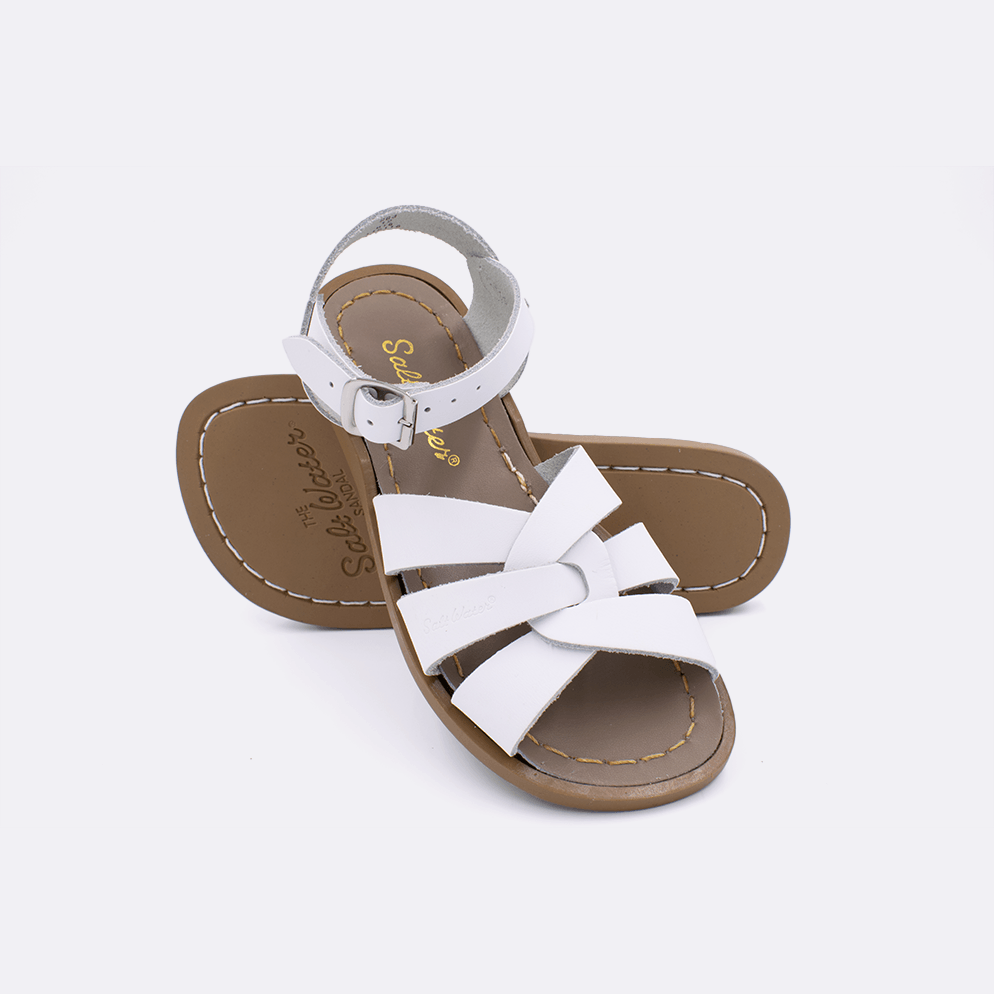 Two white little kid sized 800 Original style sandals.  One standing with the sole facing the camera. The second is laying diagonally over the top left edge of the sole.