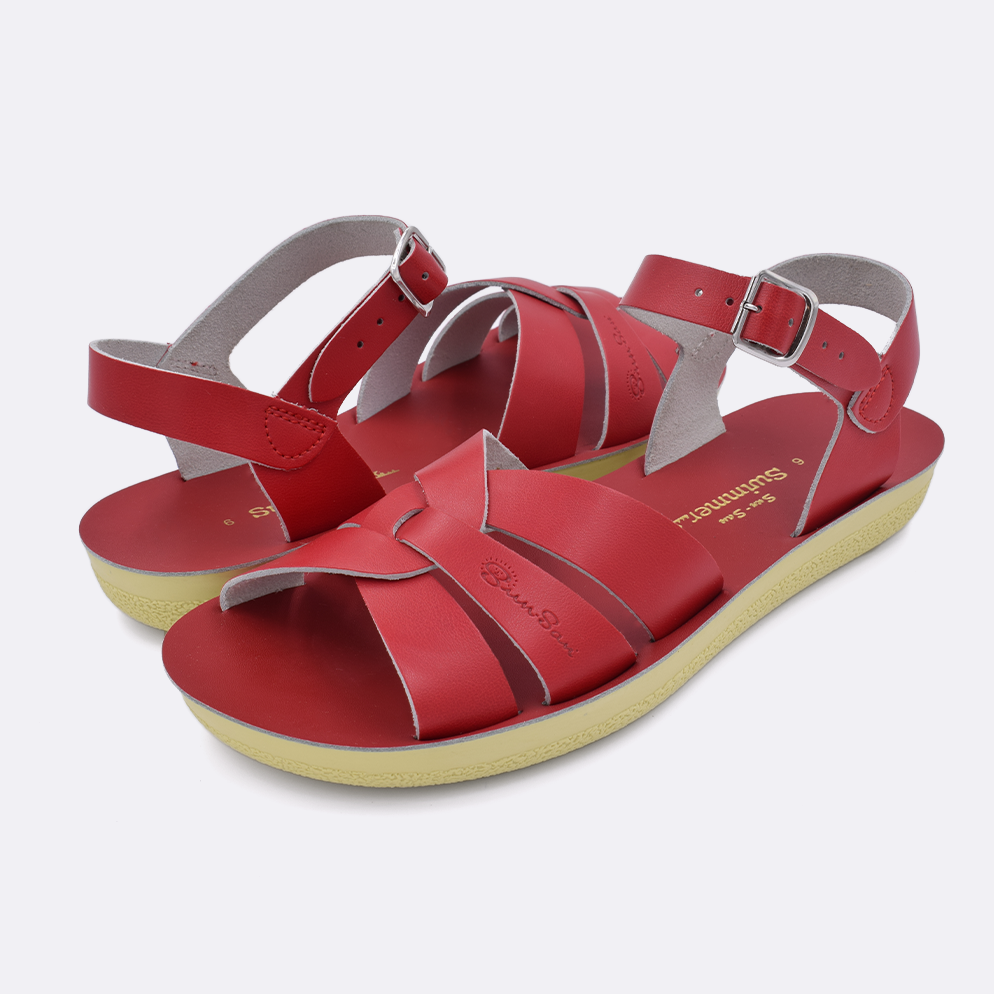 Two women's sized 8000 Swimmer style sandals with red straps and red insoles. Both pushed together facing the camera diagonally.
