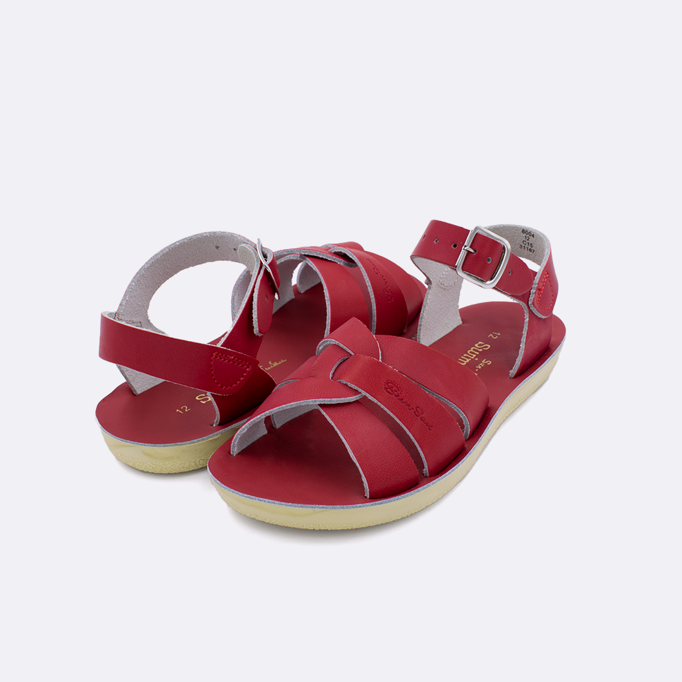 Two little kid sized 8000 Swimmer style sandals with red straps and red insoles. Both pushed together facing the camera diagonally.