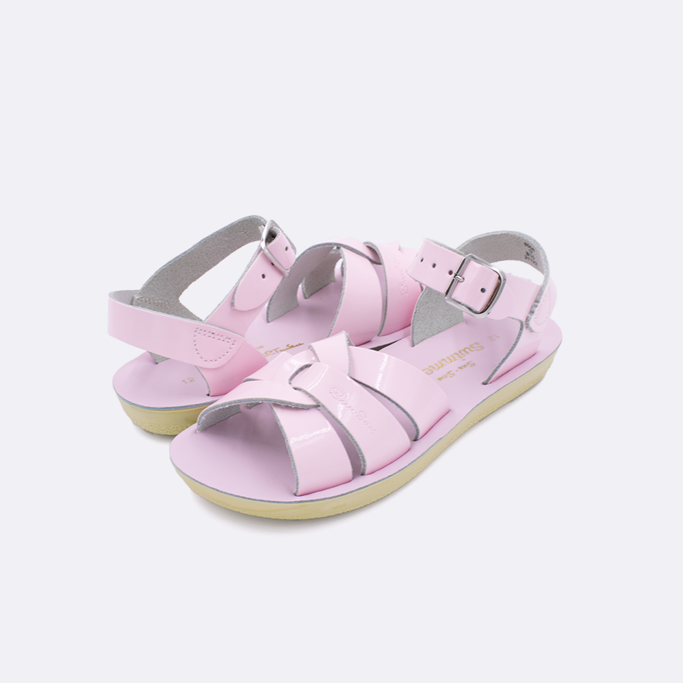 Two little kid sized 8000 Swimmer style sandals with shiny pink straps and shiny pink insoles. Both pushed together facing the camera diagonally.