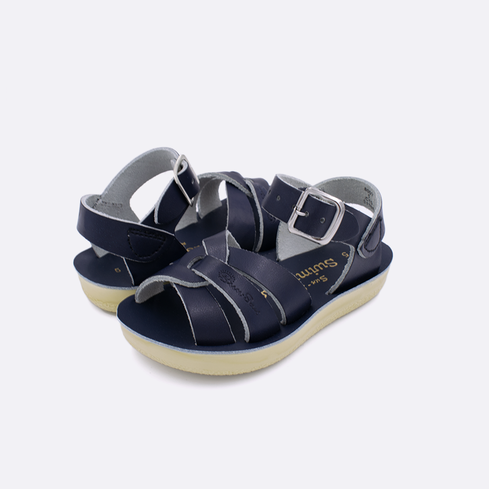 Two toddler sized 8000 Swimmer style sandals with navy straps and navy insoles. Both pushed together facing the camera diagonally.