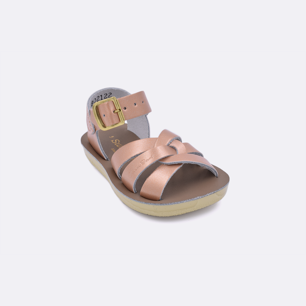 One toddler sized 8000 Swimmer style sandal with rose gold straps and a beige insole. Facing left to right diagonally. 