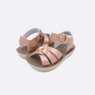 Two toddler sized 8000 Swimmer style sandals with rose gold straps and beige insoles. Both pushed together facing the camera diagonally.
