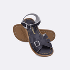 Two 900 Classic style sandals color black.  One standing with the sole facing the camera. The second is laying diagonally over the top left edge of the sole.	Little Kid Size.