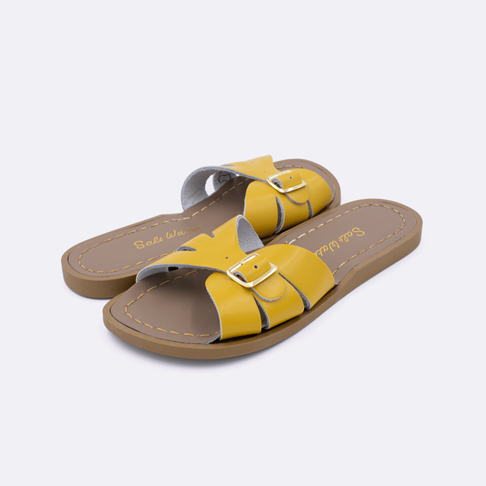 Two 9900 Classic Slide style sandal color mustard. Both pushed together facing the camera diagonally.	Little Kid Size.