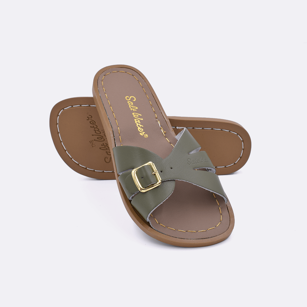 Two 9900 Classic Slide style sandals color olive.  One standing with the sole facing the camera. The second is laying diagonally over the top left edge of the sole.	Little Kid Size.
