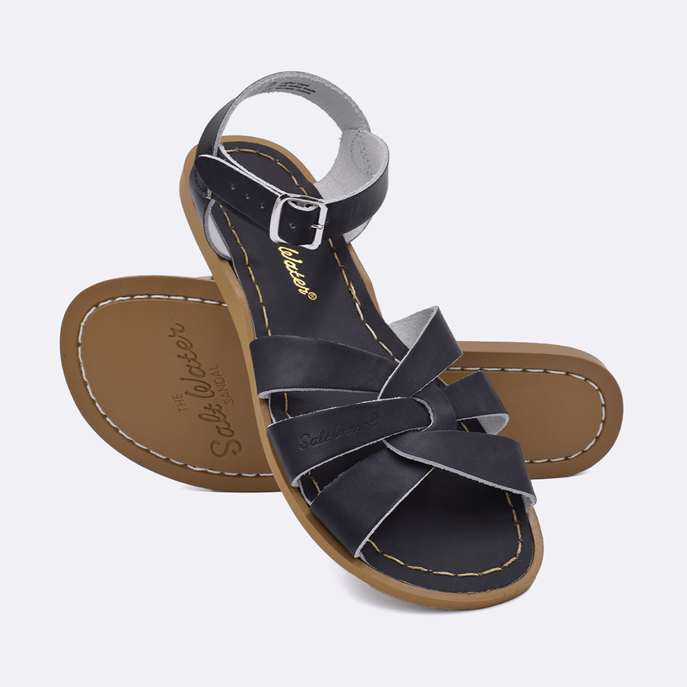 Two 800 Original style sandals color black.  One standing with the sole facing the camera. The second is laying diagonally over the top left edge of the sole.	Adult Size.
