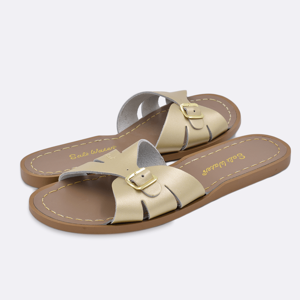 Two 9900 Classic Slide style sandal color gold. Both pushed together facing the camera diagonally.	Adult Size.