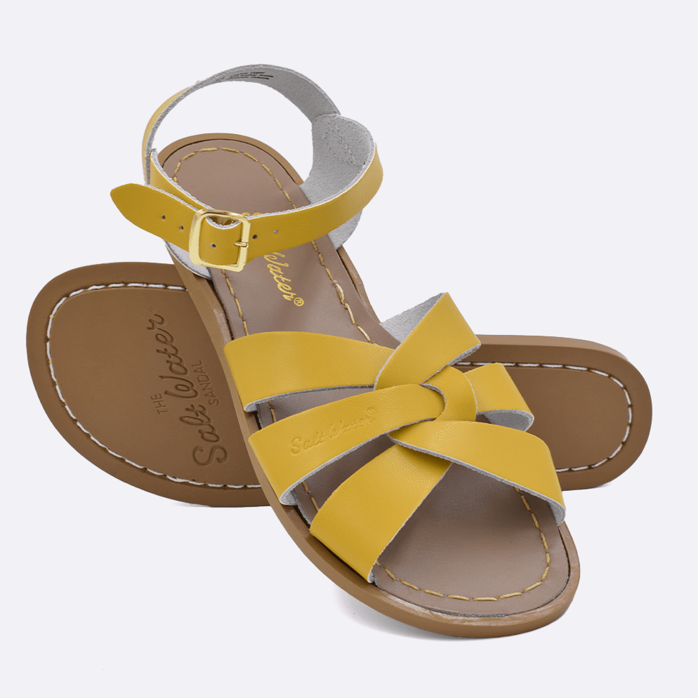 Two 800 Original style sandals color mustard.  One standing with the sole facing the camera. The second is laying diagonally over the top left edge of the sole.	Adult Size.