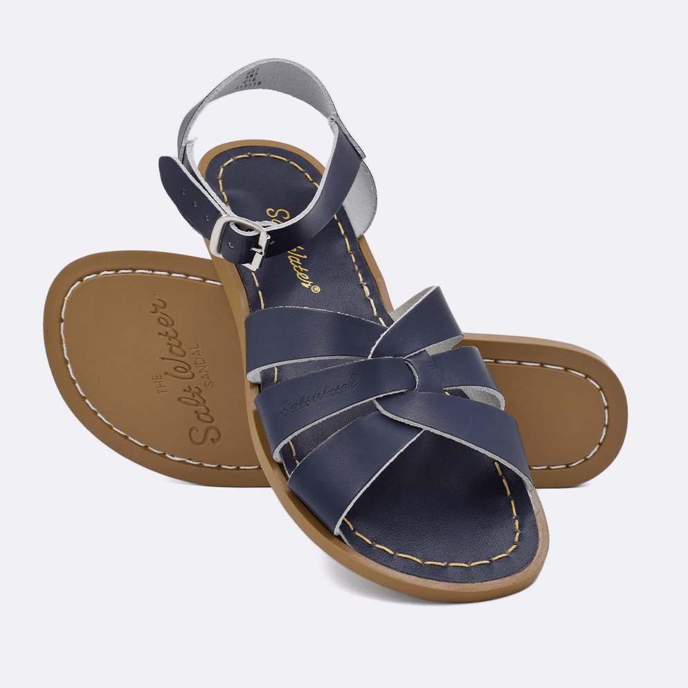Two 800 Original style sandals color navy.  One standing with the sole facing the camera. The second is laying diagonally over the top left edge of the sole.	Adult Size.