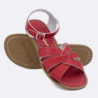 Two 800 Original style sandals color red.  One standing with the sole facing the camera. The second is laying diagonally over the top left edge of the sole.	Adult Size.