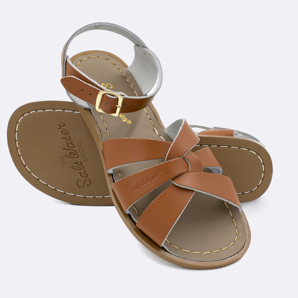 Two 800 Original style sandals color tan.  One standing with the sole facing the camera. The second is laying diagonally over the top left edge of the sole.	Adult Size.