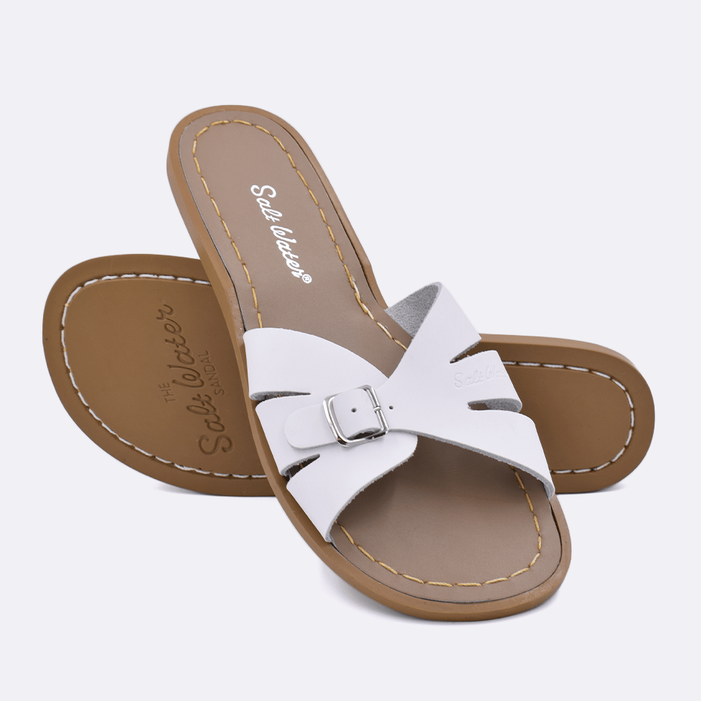Two 9900 Classic Slide style sandals color white.  One standing with the sole facing the camera. The second is laying diagonally over the top left edge of the sole.	Adult Size.