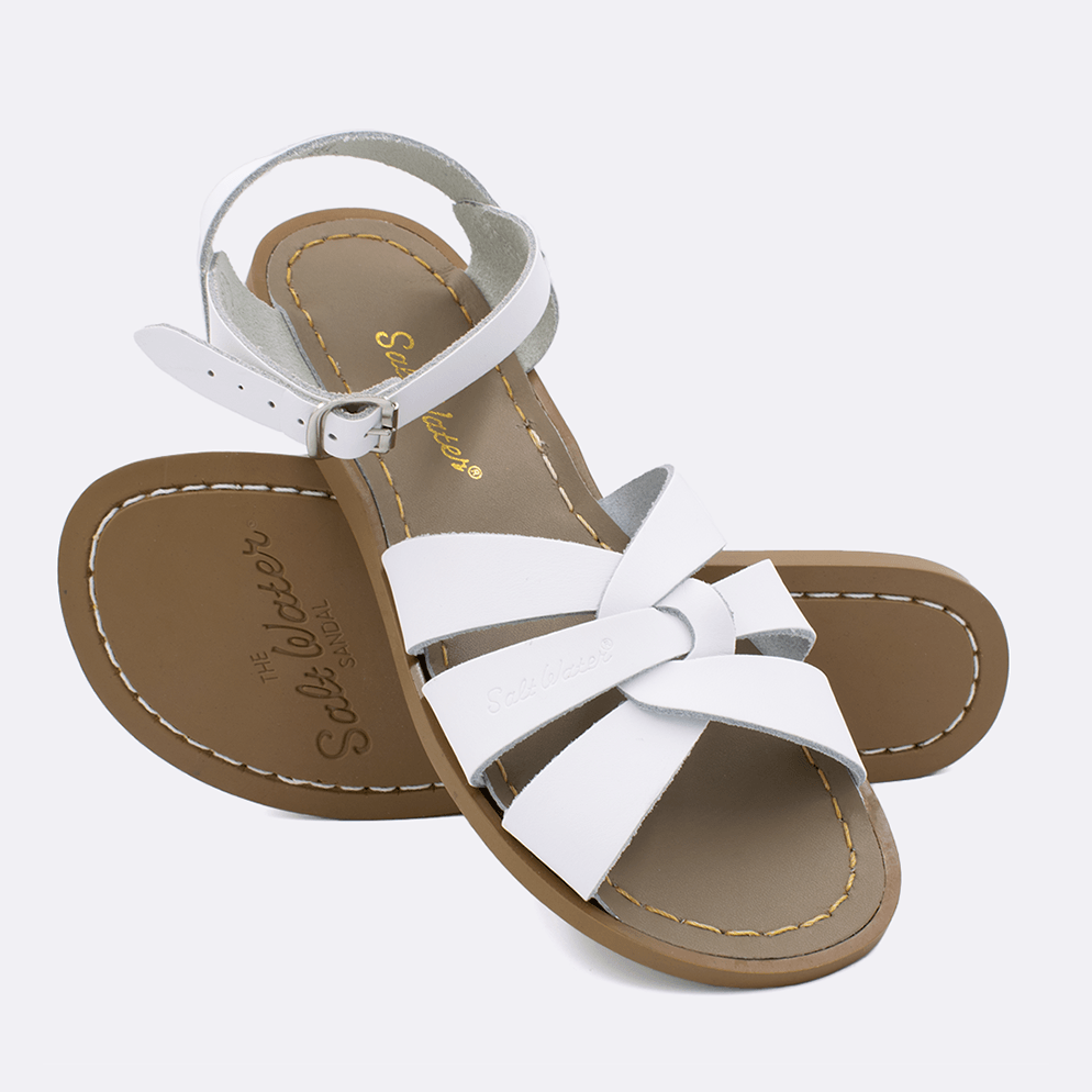 Two 800 Original style sandals color white.  One standing with the sole facing the camera. The second is laying diagonally over the top left edge of the sole.	Adult Size.